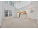 Spacious living area with high ceilings, an adjacent kitchen, and natural light from large windows at 155 Chenoa Dr. # D, Murrells Inlet, SC 29576