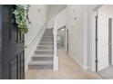 Bright foyer with tiled floor, staircase, and natural light from the doorway ahead at 155 Chenoa Dr. # E, Murrells Inlet, SC 29576