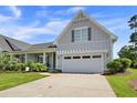 Charming single-Gathering home featuring an attached two-car garage, well-manicured lawn, and inviting curb appeal at 1584 Sand Harbor Cir. # 1584, Ocean Isle Beach, NC 28469