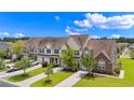 An aerial of townhomes with manicured lawns, mature trees, and a well-planned community layout at 2131 Cass Lake Dr. # 662, Carolina Shores, NC 28467