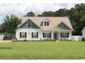 Charming two-story home with a well-manicured lawn and inviting curb appeal, enhanced by mature trees at 242 Four Mile Rd., Conway, SC 29526