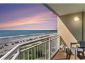 Enjoy spectacular ocean views from this condo balcony with seating and a white metal railing at 2501 S Ocean Blvd. # 503, Myrtle Beach, SC 29577