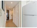 A view of a hallway with tile flooring and white appliances, along with bi-fold closet doors at 2501 S Ocean Blvd. # 503, Myrtle Beach, SC 29577