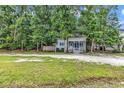 Lovely home nestled among mature trees on a grassy, gravel-covered lot at 3969 Murrells Inlet Rd., Murrells Inlet, SC 29576