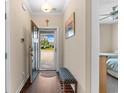 Open entryway featuring hardwood floors, a bench, neutral walls with hanging art, with outside view of the lawn at 413 Goldenrod Circle # 2B, Little River, SC 29566