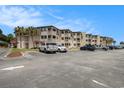 Exterior view of condos with parking and landscaping on a sunny day at 5601 N Ocean Blvd. # E-113, Myrtle Beach, SC 29577
