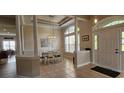 Elegant dining room boasting tile floors, tray ceiling, white columns, and lots of natural light at 6400 Longwood Dr., Murrells Inlet, SC 29576