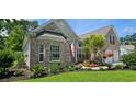 Beautiful brick home with lush green lawn, well-maintained landscaping, and American flag at 6400 Longwood Dr., Murrells Inlet, SC 29576