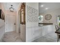 Inviting entryway featuring marble floors, decorative mirror, pendant lighting, and dining area view at 695 Riverwalk Dr. # 101, Myrtle Beach, SC 29579
