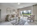 Cozy living room featuring neutral furnishings, stylish decor, and sliding doors to the patio at 695 Riverwalk Dr. # 101, Myrtle Beach, SC 29579