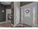 Bright entryway showcases detailed trim, a white door, and a glimpse into the bedroom at 752 Hobonny Loop, Longs, SC 29568