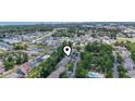 A distant aerial shot displays a community with a pool, pond, and lush foliage near the coastline at 81 Shadow Moss Pl. # 81, North Myrtle Beach, SC 29582