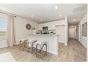 Kitchen with granite counters, stainless appliances, and breakfast bar seating at 866 Farmers Passage Loop, Loris, SC 29569