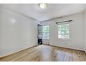 Bright bedroom with light wood floors, neutral walls, and exterior access at 1028 Duke St., Georgetown, SC 29440