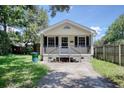 Inviting single-story home with a quaint porch and well-maintained front yard at 1028 Duke St., Georgetown, SC 29440