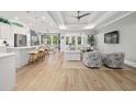 Open concept living space featuring hardwood floors, white sofas, and natural lighting at 117 Black Water Dr., Murrells Inlet, SC 29576
