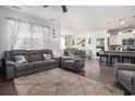 Spacious living room featuring hardwood floors, a comfortable seating arrangement, and a seamless flow to the kitchen at 1301 Camlet Ln., Little River, SC 29566