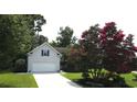 Charming home with mature landscaping, a two-car garage, and a beautifully maintained front yard at 1409 Ashwood Circle, Surfside Beach, SC 29575