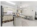 Open-concept kitchen featuring granite countertops, modern appliances, and an adjacent dining area at 181 Ella Kinley Circle # 305, Myrtle Beach, SC 29588