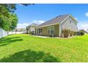 A well-maintained backyard features a lush lawn and a view of the back of the two-story home at 276 Whipple Run Loop, Myrtle Beach, SC 29588