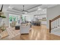 Open-concept living space with hardwood floors, modern decor, and fireplace at 3005 Purity Place Loop, Murrells Inlet, SC 29576