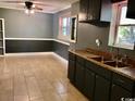 Kitchen featuring tile floors, gray walls and cabinets with sink and breakfast area at 3110 Pinewood Dr., Loris, SC 29569