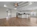 Open-concept space featuring a tray ceiling, hardwood floors, and seamless connection to the kitchen at 347 Leste Rd., Myrtle Beach, SC 29588