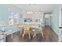 Charming dining area featuring a light wood table, wicker chairs, and a view into the kitchen at 4105 S Ocean Blvd. # 102, North Myrtle Beach, SC 29582