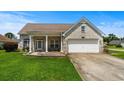 Well-maintained home with a two-car garage and landscaped front yard at 4162 Dupree Dr., Little River, SC 29566