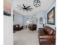 Spacious living room with modern fan, beautiful furnishings and soft, neutral carpet at 4162 Dupree Dr., Little River, SC 29566