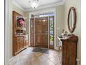 Inviting foyer with tile flooring, a decorative hutch, and a glimpse of natural light streaming through the front door at 4691 Mill Pond Ct., Murrells Inlet, SC 29576