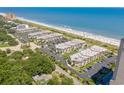 Aerial shot of the condo community near the beach, showcasing the parking and lush greenery at 5601 N Ocean Blvd. # B-314, Myrtle Beach, SC 29577