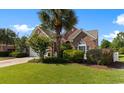 Charming single story brick home with a well manicured lawn, mature landscaping, and a paver driveway at 5712 Whistling Duck Dr., North Myrtle Beach, SC 29582