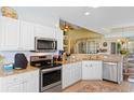 Well-equipped kitchen featuring white cabinets, stainless steel appliances, and granite countertops at 5712 Whistling Duck Dr., North Myrtle Beach, SC 29582