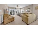 Relaxing living room featuring neutral tones, large windows, and comfortable seating area with balcony at 601 Hillside Dr. N # 3926, North Myrtle Beach, SC 29582