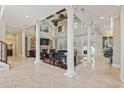 Spacious living room with high ceilings, stone columns, a fireplace, and a grand piano at 664 Oxbow Dr., Myrtle Beach, SC 29579