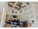Open-concept living room with soaring ceilings, fireplace, hardwood floors, and stylish furnishings at 664 Oxbow Dr., Myrtle Beach, SC 29579