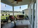 Relaxing screened porch with comfortable seating, offering a view of the community at 8164 Forest Edge Dr., Myrtle Beach, SC 29579