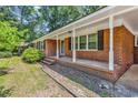 Attractive brick house with a spacious covered front porch and classic architectural details at 823 Bellamy Ave., Murrells Inlet, SC 29576