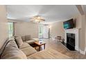 Inviting living room with neutral walls, a fireplace, ceiling fan, and wood-look flooring at 938 Fox Hollow Rd., Conway, SC 29526