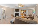 Comfortable living room features a fireplace, ceiling fan and an open floorplan to dining room and kitchen at 938 Fox Hollow Rd., Conway, SC 29526