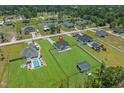 Wide aerial view of the property, showing its location within a lush, green neighborhood with a nearby pond at 1253 Kenworth Circle, Conway, SC 29526