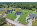 Expansive aerial shot of the property showcasing a large, well-maintained lawn, fence, and surrounding greenery at 1253 Kenworth Circle, Conway, SC 29526