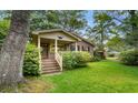 Attractive single-Gathering brick home with covered front porch, mature trees, and a lush lawn at 1272 Park Hill Dr., Conway, SC 29526