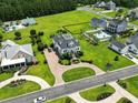 An aerial view of an estate-style home with a circular driveway, mature trees, and well-manicured landscaping at 157 Pottery Landing Dr., Conway, SC 29526