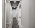 Bright hallway with a decorative ceiling, leading to the front door and other areas of the home at 2143 Stonecrest Dr. Nw, Calabash, NC 28467