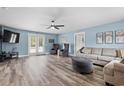 Spacious living room featuring modern fan, wood floors, and neutral paint at 241 Fannie B Rd., Conway, SC 29526