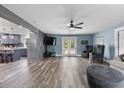 Bright living room with modern ceiling fan, wood floors, and view to kitchen at 241 Fannie B Rd., Conway, SC 29526