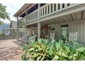 Inviting front porch featuring rocking chairs and lush greenery, creating a relaxing outdoor space at 325 Orange St., Georgetown, SC 29440