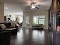 Open-concept living area featuring dark hardwood floors and seamless flow to the dining area at 340 Barony Dr., Conway, SC 29526
